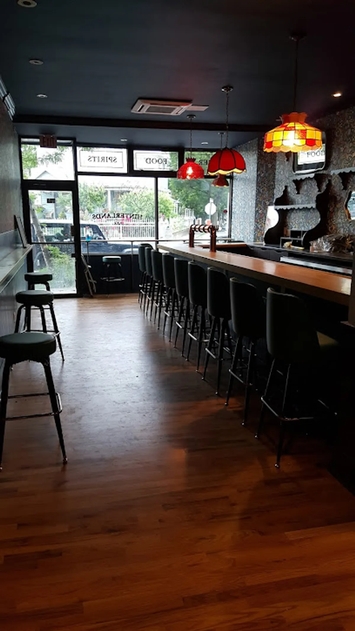 Interior view of Hinterlands Bar in Brooklyn showing patrons enjoying drinks
