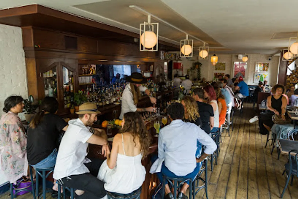 Customers enjoying drinks at Grand Army Bar in Brooklyn