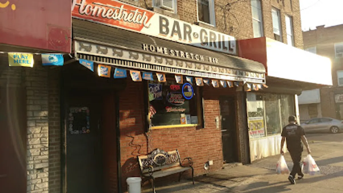 Patrons watching sports and enjoying drinks at Homestretch Bar & Grill in Brooklyn