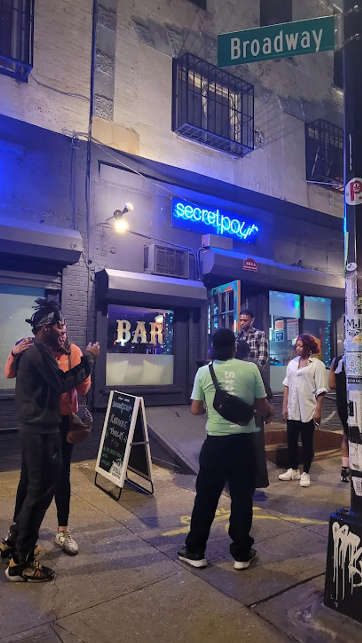 Crowded evening at Secret Pour bar with patrons enjoying drinks
