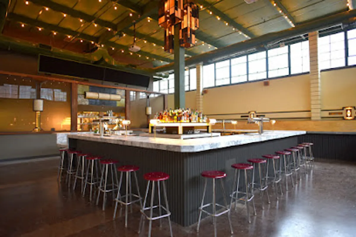 Interior view of Syndicated Bar Theater Kitchen showing dining and cinema space.
