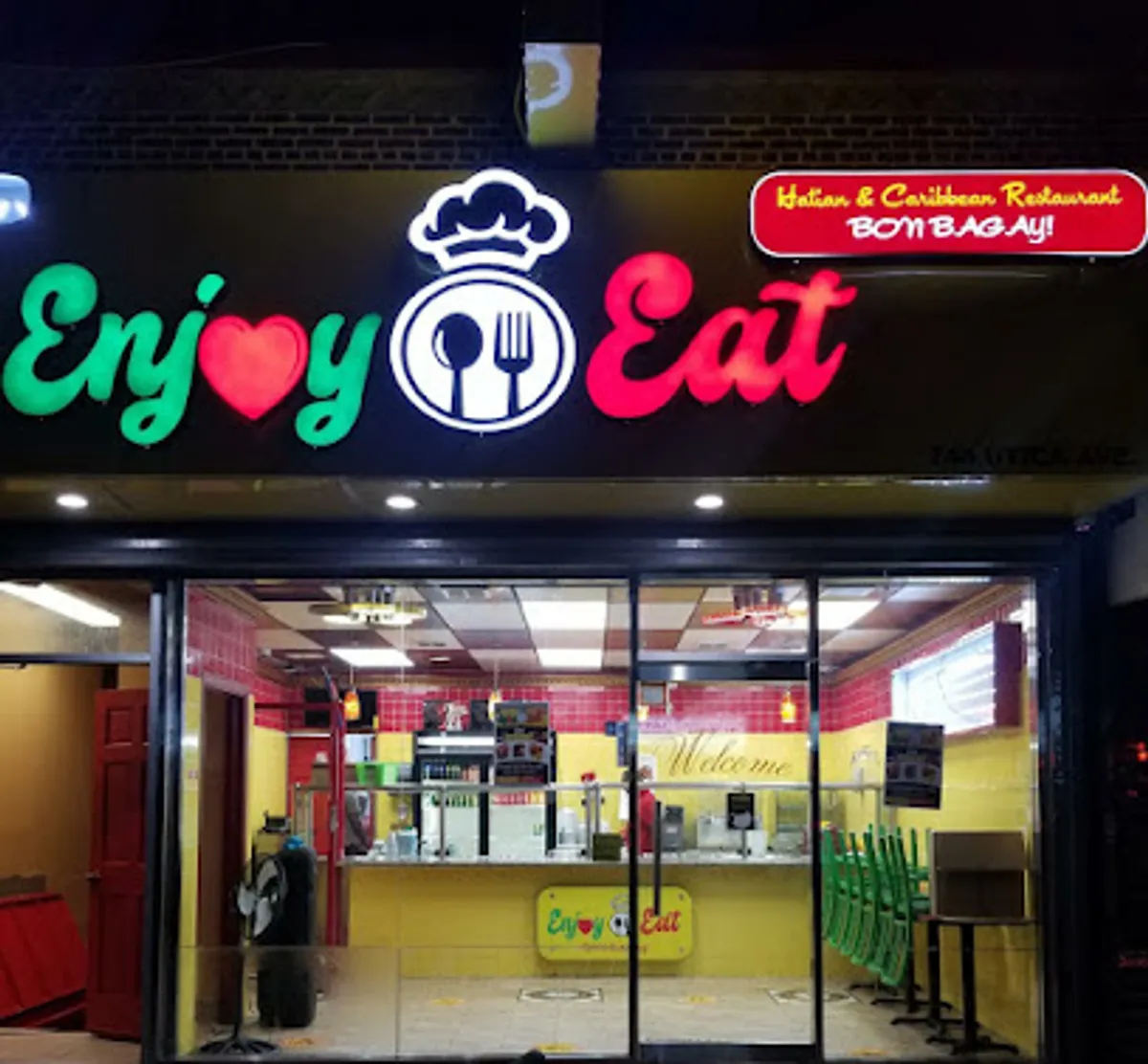 Interior view of ENJOY EAT restaurant filled with diners enjoying Haitian cuisine